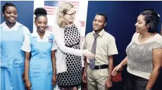  ?? KENYON HEMANS/PHOTOGRAPH­ER ?? Maura Barry-Boyle (centre), acting deputy chief of mission at the US Embassy, greets Kadeshia Hill (right), guidance counsellor at Ardenne High School, who came to view ‘Girls Rising’ along with some of her students. From left are Kadeen Grant, Aleesha...