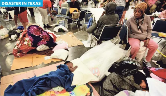  ?? PHOTOS BY HENRIETTA WILDSMITH, USA TODAY NETWORK ?? Vivian Bell watches over her grandchild­ren Tuesday inside the George R. Brown Convention Center in Houston. The shelter held 9,000 as of late Tuesday.