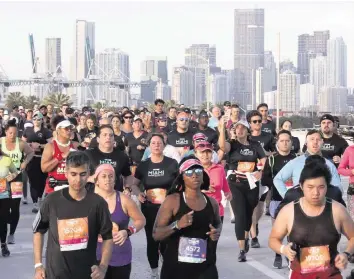  ?? CARL JUSTE cjuste@miamiheral­d.com ?? Runners make their way toward the 5th Street exit on the MacArthur Causeway during the 18th-annual Life Time Miami Marathon and Half Marathon on Feb. 9, 2020. There were more than 20,000 combined registered runners.