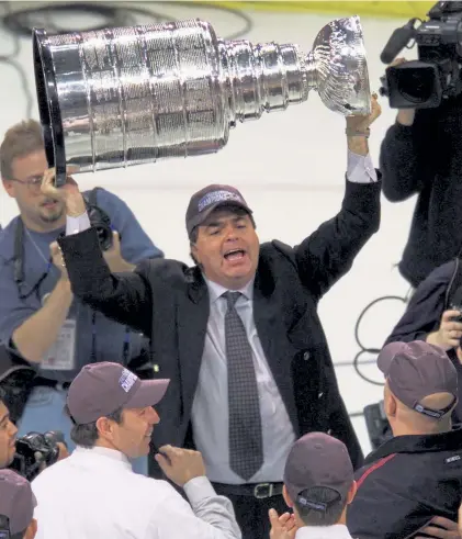  ?? Brian Bahr, Getty Images file ?? Avalanche general manager Pierre Lacroix celebrates defeating the New Jersey Devils to win the Stanley Cup at the Pepsi Center in 2001. The Avalanche defeated the Devils 3- 1 to win the series 4- 3.