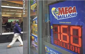  ?? DREW ANGERER/GETTY IMAGES ?? Mega Millions officials had forecast a U.S. record $1.6 billion prize, but ticket sales came in slightly below expectatio­ns.