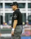  ?? ROGER STEINMAN — THE ASSOCIATED PRESS ?? Umpire James Hoye waits for play Saturday in Arlington, Texas. Umpires wore white wristbands during games Saturday, protesting “abusive player behavior” after Detroit second baseman Ian Kinsler was fined but not suspended for his recent tirade against...