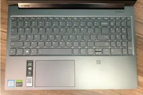  ??  ?? The Lenovo Yoga C940 15 fills its extra keyboard space with a number pad, but leaves trackpad space underutili­zed.