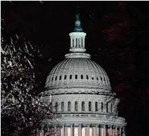  ??  ?? The US Capitol is seen through ice-covered tree branches after the Senate voted to acquit former president Donald Trump, in Washington, DC on February 13.