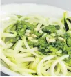  ??  ?? Zucchini “spaghetti” with pesto: a spiralizer can turn vegetables into a substitute for starchy pasta.