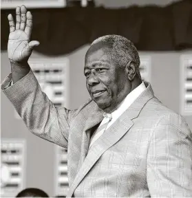  ?? Mike Groll / Associated Press ?? Hall of Famer Hank Aaron waves during his induction July 28, 2013, in Cooperstow­n, N.Y. The author interviewe­d the baseball great in November.