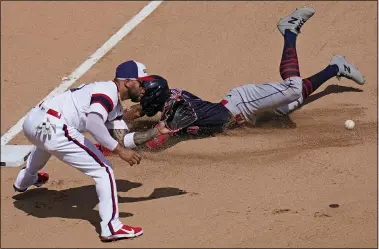  ?? NAM Y. HUH — THE ASSOCIATED PRESS ?? The Indians’ Amed Rosario slides safely into third base after hitting a triple as White Sox third baseman Yoan Moncada waits for the ball during the fourth inning.