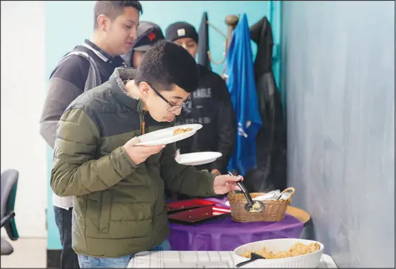  ?? PHOTOS BY GODOFREDO A. VÁSQUEZ / ASSOCIATED PRESS ?? Jefferson Martinez smells the chipotle arroz con pollo before trying the dish Jan. 13 as Mount Diablo High School students participat­ed in a taste test in Concord, Calif. The school district in suburban San Francisco has been part of a national “farm-to-school” movement for years, where schools try to buy as much locally as possible. But the mission has been kicked into higher gear with a California program that provides free meals to all public school students in the state, along with unpreceden­ted new funding.