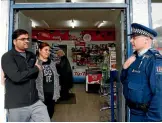  ?? MARTIN DE RUYTER/NELSON MAIL ?? Vijay, left, and Darshini Chauhan speak with Nelson Police Senior Sergeant Blair Hall following an armed robbery where tobacco was stolen from the dairy they manage.