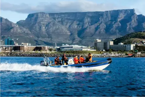  ?? ?? Making waves: tourists motor across the bay in Cape Town (South Africa Tourism)