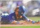  ?? JOE CAMPOREALE/USA TODAY SPORTS ?? The Dodgers’ Justin Turner loses his helmet as he slides safely during a game in 2018.