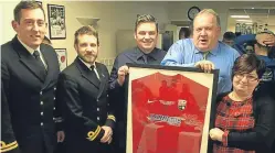  ??  ?? Graeme Smith and Rosie Carnegie receive the strip from Legion vice-chairman Ally Hutchison, centre, as Lt Dave Salberg, left, and Lt James Young from HMS Montrose look on.