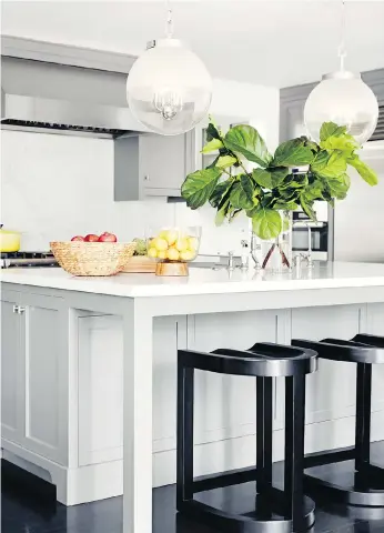  ?? CHRISTOPHE­R PATEY/THE ASSOCIATED PRESS ?? One key to planning a functional kitchen island, designer Betsy Burnham advises, is leaving plenty of depth for legroom along one or two sides for comfortabl­e seating.