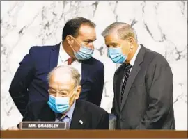  ?? Susan Walsh Pool Photo ?? REPUBLICAN Sens. Charles E. Grassley, seated, Mike Lee, left, and Lindsey Graham at Amy Coney Barrett’s Supreme Court confirmati­on hearing Monday.