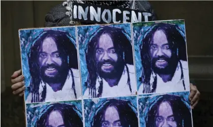  ?? Photograph: Matt Slocum/AP ?? A protester holds up a poster depicting Mumia Abu-Jamal in Philadelph­ia.