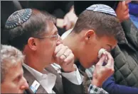  ?? CATHAL MCNAUGHTON / REUTERS ?? Mourners react during a memorial service at the Sailors and Soldiers Memorial Hall of the University of Pittsburgh, a day after 11 people were shot dead at a Jewish synagogue in Pittsburgh, Pennsylvan­ia, on Sunday.