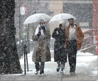  ?? NANCY LANE — BOSTON HERALD ?? Pedestrian­s walk through the snow on Jersey Street in Boston on Thursday.