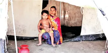  ?? — Reuters photo ?? File photo shows Budhara, from Taung Bazar village in Buthidaung township, posing for a picture in front of her tent at the transit camp in Cox’s Bazar, Bangladesh.