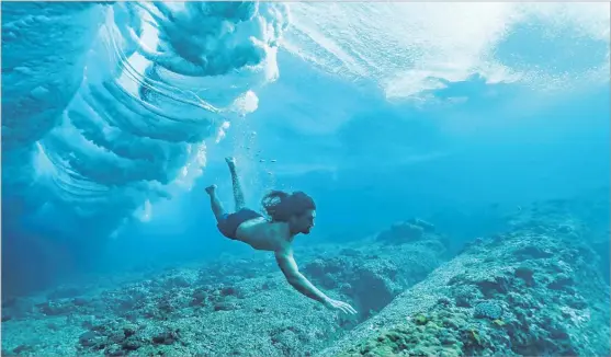  ?? Picture: SUPPLIED by SURFLINE ?? Lead scientist Dr Cliff Kapono dives under the waves at Cloudbreak, Tavarua.