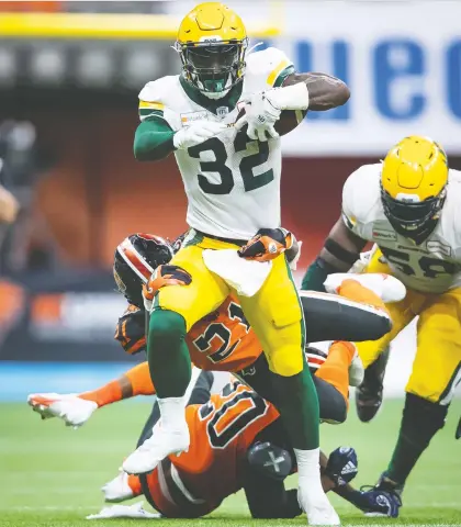  ?? DARRYL DYCK/THE CANADIAN PRESS ?? The Edmonton Elks' James Wilder Jr. is tackled by the B.C. Lions' Jordan Williams as he carries the ball during the second half of their game in Vancouver on Thursday. The Elks went on to give Jaime Elizondo his first win as a CFL head coach.