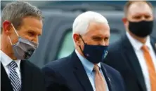  ?? JOE RONDONE/ THE COMMERCIAL APPEAL VIA AP ?? Vice President Mike Pence, right, and Tennessee Gov. Bill Lee talk on the tarmac at the Air National Guard 164th Airlift Wing prior to a roundtable discussion about Operation Warp Speed last week in Memphis.