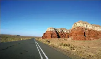  ?? Giovanna Dell’Orto / AP files ?? Top: Vehicles drive through Turnagain Pass on the Kenai Peninsula, Ala., on the Seward Highway. Bottom: This photo shows roadside views on a drive from Canyon de Chelly National Monument to Monument Valley Navajo Tribal Park.