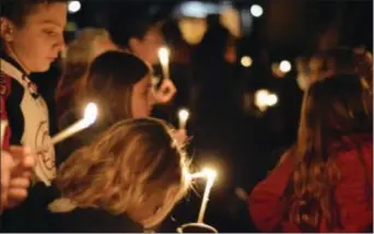  ?? RUSSELL CONTRERAS — THE ASSOCIATED PRESS ?? Aztec High School students and area residents gather for a candleligh­t vigil in Aztec, N.M., Thursday after a shooting at the high school. Students hid in their classrooms, some behind locked doors, as a suspect opened fire Thursday inside the school,...