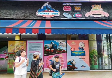  ??  ?? Town down: Visitors walking near the entrance to sanrio’s Hello Kitty Town theme park in Iskandar Puteri.