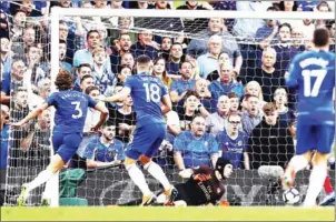  ?? AFP ?? Chelsea defender Marcos Alonso (left) shoots past Arsenal goalkeeper Petr Cech to score his side’s winner in their English Premier League match on Saturday.