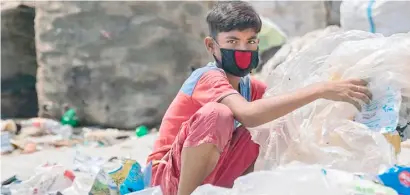  ??  ?? TWELVE-year-old boy in Dhaka, capital of Bangladesh sorts through hazardous plastic waste without any protection, working to support his family amid the lockdown.