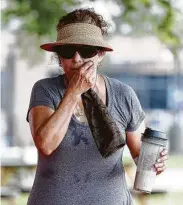  ?? Karen Warren / Staff photograph­er ?? Edith Ramos uses a towel to wipe sweat from her face after a Zumba class.