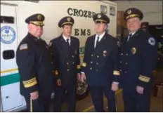  ?? PETE BANNAN - DIGITAL FIRST MEDIA ?? Crozer EMS officers in front of the medic unit that will be used to carry the body of Chief Robert Reeder at his funeral Thursday. Left to right. Assistant Chief Jeff Witters, Delco Hospital Chief Richard Micun, and assistant chiefs Larry Worrilow and Chief Bruce Egan.