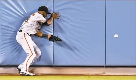  ?? Harry How / Getty Images ?? Giants center fielder Austin Jackson muffs a fly ball that eventually led to a run that gave the Dodgers a 3-2 victory.