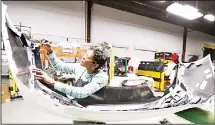  ??  ?? In this file photo, final inspector Mary Skinner inspects the rear end of a General Motors Chevrolet Cruze at Jamestown Industries in Youngstown, Ohio. On Dec 3, the Institute for Supply Management, a trade group of purchasing managers, issues its index of manufactur­ing activity for November. (AP)