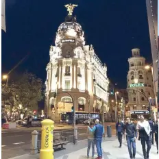  ??  ?? One of the famous buildings in Madrid, Metropolis, opens the Gran Via, a major tourist artery.