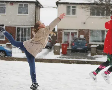  ??  ?? Left: Footpaths are cleared in Kildare town. Above: Alex McDonnell (11) and Mia Lawlor (10) from Glasnevin in Dublin. Right: A robin in Dunboyne, Co Meath; Anne Downey (100), from Dundalk, Co Louth; and a woman walks on Luas tracks in Dublin. Photos:...