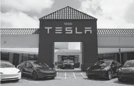  ?? XINHUA USA TODAY NETWORK ?? Vehicles are displayed at a Tesla store on April 15 in San Mateo, California. Tesla reported Tuesday that its profit fell 55% from the first quarter of 2023, and revenue fell 9%.