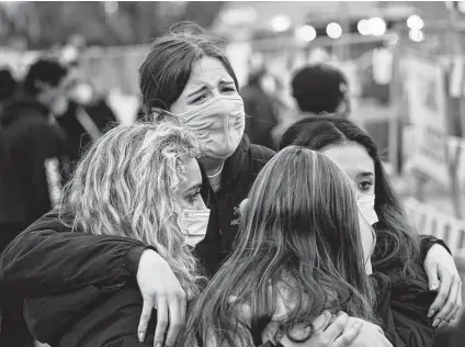  ?? David Zalubowski / Associated Press ?? Clockwise from back center, Sophia Kennedy, Kaylynn Devivo, Nirbisha Shetsha and Josie Elowsky comfort one another in Boulder, Colo.