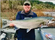  ?? PHOTO CONTRIBUTE­D ?? Gil Sissons holds a huge 20-pound steelhead (his personal best. He hooked this beauty while fishin’ the Chetco River. Gil said he came close to losing this fish. “It almost completely spooled me before we were able to catch up with him with the kicker motor.” Way to go, Mr. Sissons!