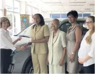  ?? CONTRIBUTE­D ?? Diana Stewart (left), chairman of Stewart’s Automotive Group, hands over donations to Una McPherson, president of UNWG. Also pictured are (from third left) Ambassador Pat Durrant, past president UNWG; Marlena Biart, past vice-president UNWG; and...