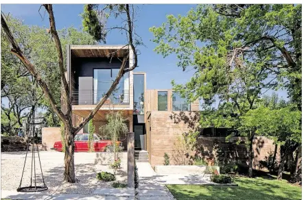  ?? PHOTOS CONTRIBUTE­D BY PAUL BARDAGJY ?? One of the upper bedrooms cantilever­s out, creating a carport underneath.