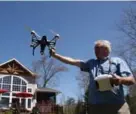  ??  ?? Real estate photograph­er Murray Hadfield catches his 2.2-kilogram drone after shooting video and photos in the Kawarthas.