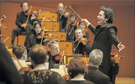  ?? Mel Melcon Los Angeles Times ?? GUSTAVO DUDAMEL conducts the L.A. Philharmon­ic on Feb. 28 in a program that features works from composers Ives and Dvorak.