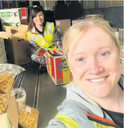  ??  ?? Hayley Williams and Stephanie Edwards, left, are distributi­ng food to vulnerable residents