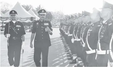  ??  ?? Ramli inspecting the guard of honour at the monthly gathering yesterday.