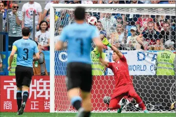  ?? — AFP photo ?? (Photo left) France’s goalkeeper Hugo Lloris dives to stop the ball and (photo right) Uruguay’s goalkeeper Fernando Muslera deflects the ball into his net leading to France’s second goal during the Russia 2018 World Cup quarter-final football match...