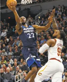  ?? Jim Mone / Associated Press ?? The Timberwolv­es’ Andrew Wiggins lays up a shot past the Cavaliers’ Jae Crowder during Minnesota’s home victory.