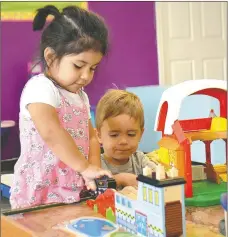  ?? Janelle Jessen/Herald-Leader ?? Olivia Tun, 3, and Maxon Welch, almost 3, played at a train table inside the Siloam Springs Children’s Center last week. The center was recently acquired by Friendship Community Care.