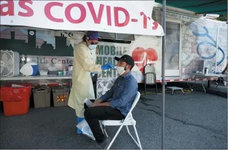  ?? ELISE AMENDOLA — ASSOCIATED PRESS ?? Nurse Tanya Markos administer­s a coronaviru­s test on patient Ricardo Sojuel at a mobile COVID-19testing unit July 2in Lawrence, Mass.