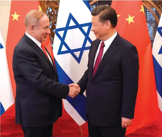 ?? (Etienne Oliveau/Reuters) ?? CHINESE PRESIDENT XI Jinping and Prime Minister Benjamin Netanyahu shake hands ahead of their talks at Diaoyutai State Guesthouse in Beijing in 2017.